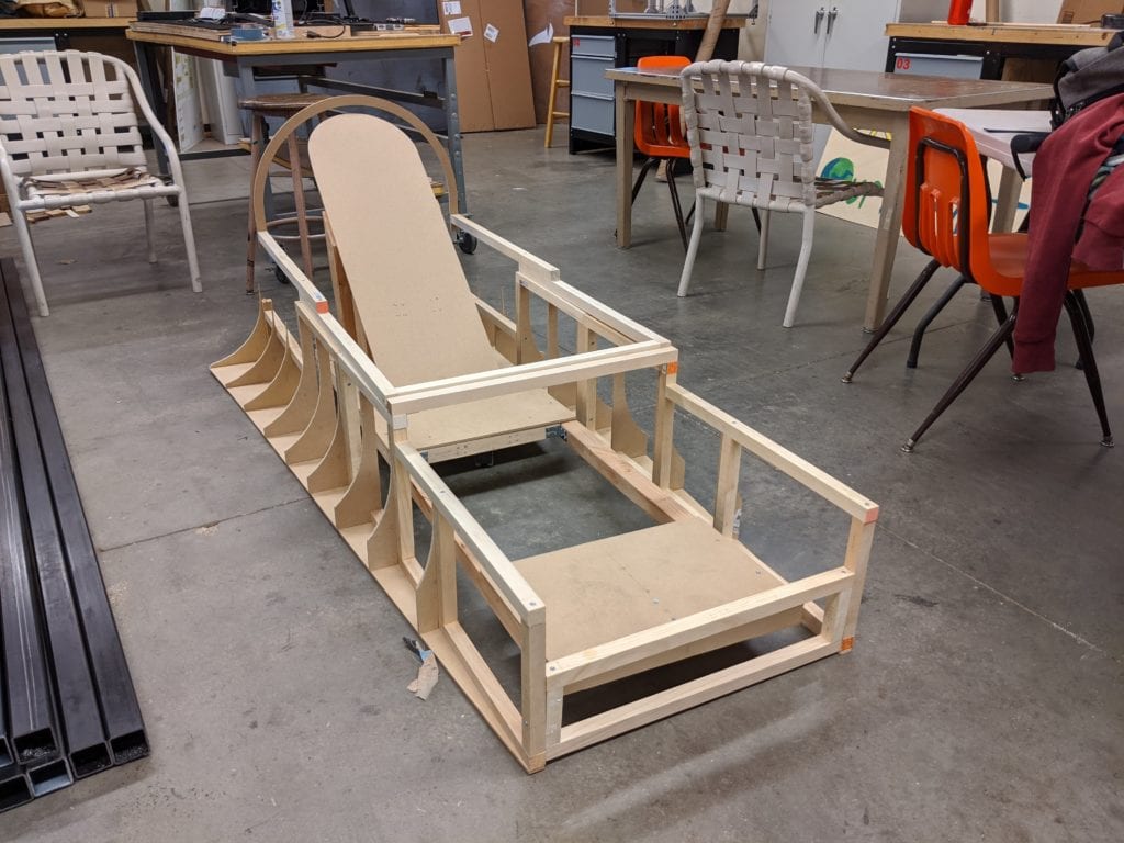 The extent of our build before Covid-19 hit. A wooden fuselage frame, wooden top hatch frame, and wooden rolling pilot seat.