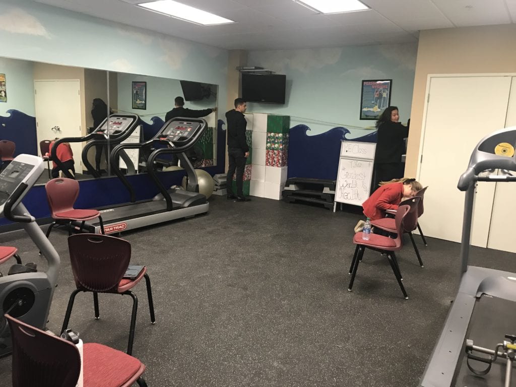 Image of current exercise room at Achievement House. Materials available are resistance racks, treadmills, and bouncy balls.