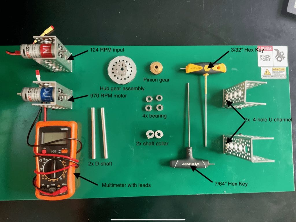 Layout of all components needed for the guided activity. One Input motor, one output motor, multimeter, two shafts, one gear and one pinion gear, four bearings, two shaft collars, two hex keys, and two pillars.
