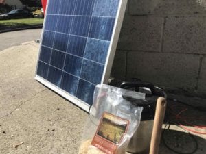 A 100 watt solar panel attached to our insulated cooker. We cooked rice and beans in the device on a sunny day.